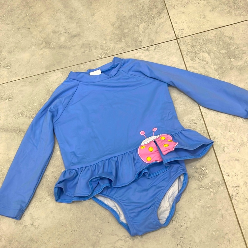 Periwinkle Rash Guard Tankini With Ladybug. It is two pieces.